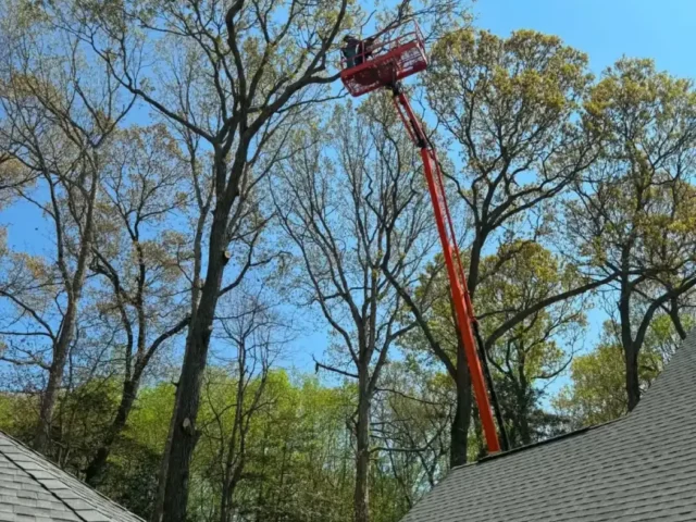 Boom lift reaching over the roofline