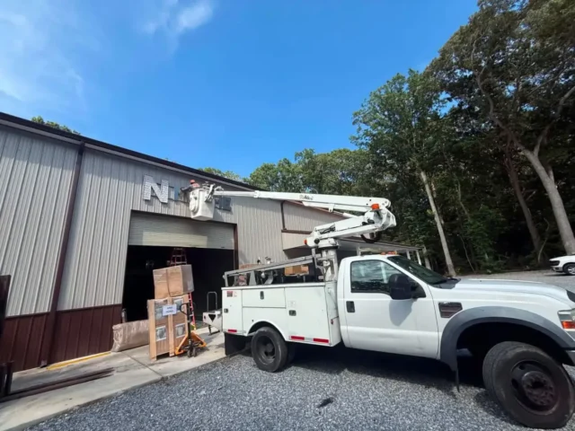 Bucket truck working at the shop door