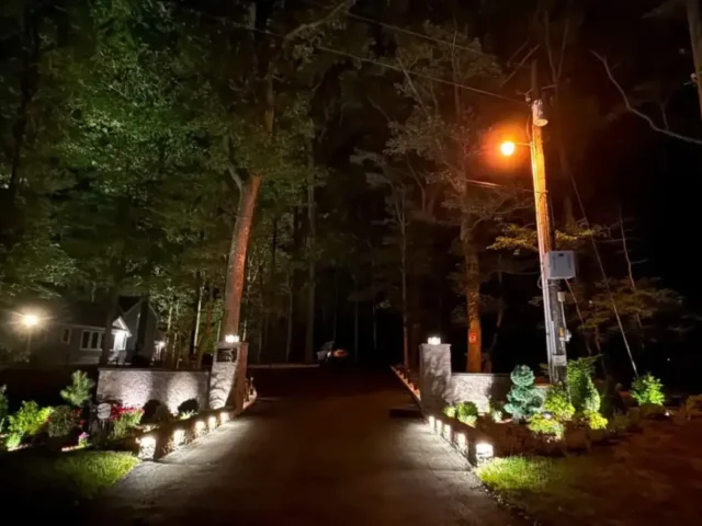 Driveway entrance lit at night