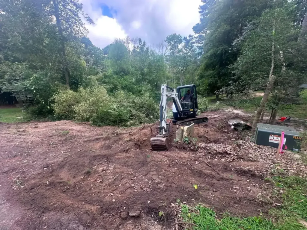 Mini excavator clearing an overgrown yard