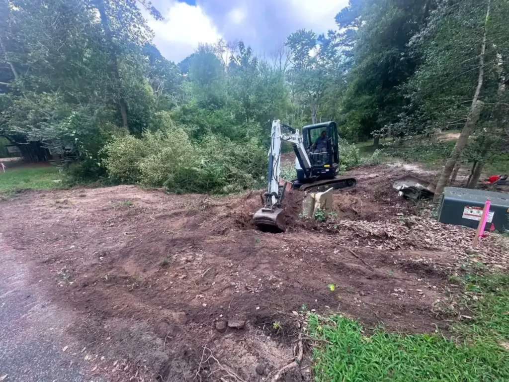Mini excavator working on a freshly cleared lot