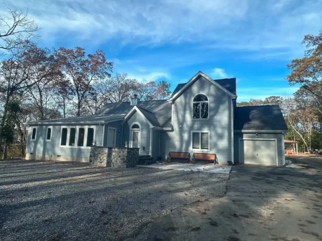Finished house with new siding and a stone entry