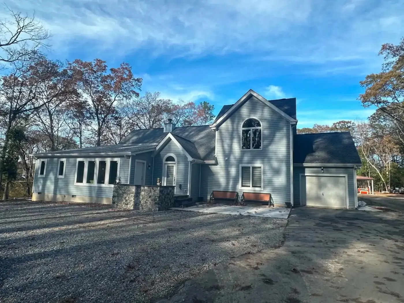 Finished house with new siding and a stone entry