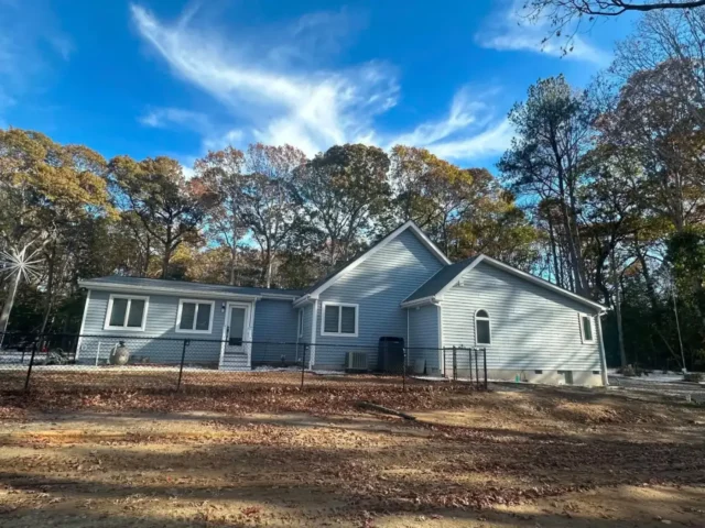 House with new siding seen from the side yard