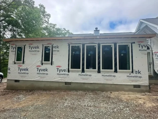 House wrapped and fitted with new windows